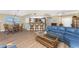 Bright living room features wood floors, breakfast bar, and cozy blue sofa with view of the kitchen at 101 N Marion Ct # 215, Punta Gorda, FL 33950