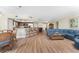 Spacious open-concept living area with hardwood floors, bar seating, and views into kitchen at 101 N Marion Ct # 215, Punta Gorda, FL 33950