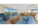 Comfortable living area featuring hardwood flooring, bar seating, and sliding glass doors to balcony at 101 N Marion Ct # 215, Punta Gorda, FL 33950