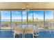 Inviting screened-in patio with tiled floor and beautiful ocean views, perfect for outdoor dining and relaxation at 101 N Marion Ct # 215, Punta Gorda, FL 33950