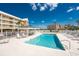 Community pool with ample lounge seating and a gazebo, set against the backdrop of lush landscaping and ocean view at 101 N Marion Ct # 215, Punta Gorda, FL 33950
