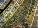 Aerial view highlighting the property's location within a residential area, showcasing proximity to natural wooded space at 1025 Boundary Blvd, Rotonda West, FL 33947