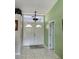 Inviting foyer with natural light, neutral walls, tiled floors and beautiful double door at 1025 Boundary Blvd, Rotonda West, FL 33947