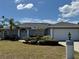 Charming single-story home with a manicured lawn, featuring classic architectural details and an attached two-car garage at 1025 Boundary Blvd, Rotonda West, FL 33947