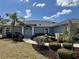 Charming home featuring manicured landscaping, healthy green lawn, and a beautiful walkway leading to the front door at 1025 Boundary Blvd, Rotonda West, FL 33947