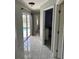 Hallway with marble floors leading to the pool area through sliding glass doors at 1025 Boundary Blvd, Rotonda West, FL 33947