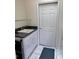 A laundry room with a utility sink and countertop at 1025 Boundary Blvd, Rotonda West, FL 33947