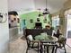 Open-concept living area featuring stylish decor, comfortable seating, and seamless transitions between the dining and living spaces at 1025 Boundary Blvd, Rotonda West, FL 33947