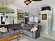 Spacious living area with a large sectional sofa, open layout, and seamless flow into the kitchen and dining area at 1025 Boundary Blvd, Rotonda West, FL 33947