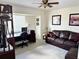 Cozy living room with a comfortable leather couch, a desk, and natural light at 1025 Boundary Blvd, Rotonda West, FL 33947