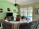 Cozy living room with comfortable seating, a ceiling fan, and access to the pool area at 1025 Boundary Blvd, Rotonda West, FL 33947