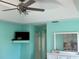 Stylish main bedroom with a modern ceiling fan and a wall-mounted television at 1025 Boundary Blvd, Rotonda West, FL 33947