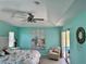 Coastal bedroom with ceiling fan, light-colored walls, and slider door leading to pool at 1025 Boundary Blvd, Rotonda West, FL 33947