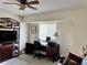 Well-lit office space with a ceiling fan, desk, and comfortable seating at 1025 Boundary Blvd, Rotonda West, FL 33947