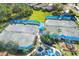 Aerial view of the community tennis courts and playground, with mature landscaping and a gazebo at 1215 Jonah Dr, North Port, FL 34289