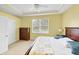 Bedroom featuring neutral carpet, tray ceiling, and large window at 1215 Jonah Dr, North Port, FL 34289