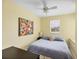 Cozy bedroom with yellow walls, a ceiling fan, and a window with natural light at 1215 Jonah Dr, North Port, FL 34289