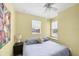 Comfortable bedroom with yellow walls, window seat, and a ceiling fan at 1215 Jonah Dr, North Port, FL 34289