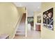 Welcoming entryway featuring a staircase, tile flooring, and a glimpse into the living room at 1215 Jonah Dr, North Port, FL 34289