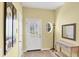 Bright foyer with neutral tones, complemented by stylish decor and a round window feature at 1215 Jonah Dr, North Port, FL 34289