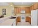 Functional kitchen featuring wood cabinetry, modern appliances, and ample counter space at 1215 Jonah Dr, North Port, FL 34289