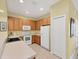 Bright kitchen showcasing sleek appliances, warm cabinetry, and tiled flooring at 1215 Jonah Dr, North Port, FL 34289