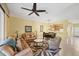 Open-concept living area with tile floors and view of the kitchen beyond the dining area at 1215 Jonah Dr, North Port, FL 34289