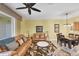 Open-concept living area showcasing sofas, a ceiling fan, tile floors, and dining space at 1215 Jonah Dr, North Port, FL 34289