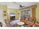 Bright living room with tile floors, comfortable seating, and sliding doors to the lanai at 1215 Jonah Dr, North Port, FL 34289