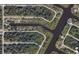 Aerial view of 13236 Pace Cir property nestled along a canal with lush landscaping and neighborhood streets at 13236 Pace Cir, Port Charlotte, FL 33981