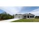 Charming single-story home with a three car garage and well-manicured lawn at 13236 Pace Cir, Port Charlotte, FL 33981