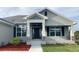 Charming front entrance features stone accents, pillars and detailed trim work at 13236 Pace Cir, Port Charlotte, FL 33981