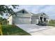 Spacious three car garage with stone accents and carriage style doors at 13236 Pace Cir, Port Charlotte, FL 33981