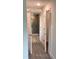 Hallway showcasing tile floors and tiled glass shower in the adjacent bathroom at 13236 Pace Cir, Port Charlotte, FL 33981