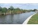 Scenic waterfront view with lush greenery, showcasing the property's serene canal access and beautiful surroundings at 13236 Pace Cir, Port Charlotte, FL 33981