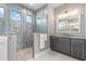 Bathroom features a stone shower with multiple windows, gray vanity and floors, and a large mirror at 1330 Mineo Dr, Punta Gorda, FL 33950