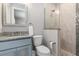 This bathroom has a stone walk-in shower, and a vanity with a gray counter and light blue cabinets at 1330 Mineo Dr, Punta Gorda, FL 33950