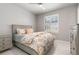 This is a well lit bedroom with a large window, white floors, and a gray color scheme at 1330 Mineo Dr, Punta Gorda, FL 33950