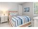 This is a bedroom with a bright window, white walls and floors, and a painting of sailboats at 1330 Mineo Dr, Punta Gorda, FL 33950