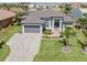 Beautiful single Gathering home features a well-manicured lawn, brick paved driveway, and a two car garage at 1330 Mineo Dr, Punta Gorda, FL 33950