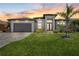 Beautiful single-story home with a gray exterior, lush green lawn, and a well-manicured landscape at 1330 Mineo Dr, Punta Gorda, FL 33950