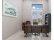Well-lit home office with a dark wood desk, shutters, and an art piece at 1330 Mineo Dr, Punta Gorda, FL 33950