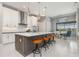 Open-concept kitchen with a center island, modern pendant lights, and a breakfast bar at 1330 Mineo Dr, Punta Gorda, FL 33950