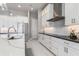 Bright kitchen features white cabinets, stainless steel appliances, and a marble countertop island at 1330 Mineo Dr, Punta Gorda, FL 33950