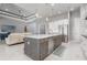 Open-concept kitchen boasts an island with seating, marble countertops, and stainless steel appliances at 1330 Mineo Dr, Punta Gorda, FL 33950