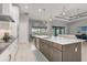 Modern kitchen with white cabinets, a center island, and open to the living room at 1330 Mineo Dr, Punta Gorda, FL 33950