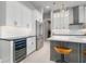 Beautiful white kitchen featuring a wine cooler, stainless steel appliances, and a center island at 1330 Mineo Dr, Punta Gorda, FL 33950