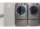 New gray front loading washer and dryer units inside of a gray walled laundry room at 1330 Mineo Dr, Punta Gorda, FL 33950