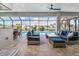 Screened patio with comfortable seating, ceiling fan, brick floors and view of the pool at 1330 Mineo Dr, Punta Gorda, FL 33950
