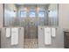 Large walk-in shower features dual shower heads, stone floors, and a stone wall with 3 windows at 1330 Mineo Dr, Punta Gorda, FL 33950